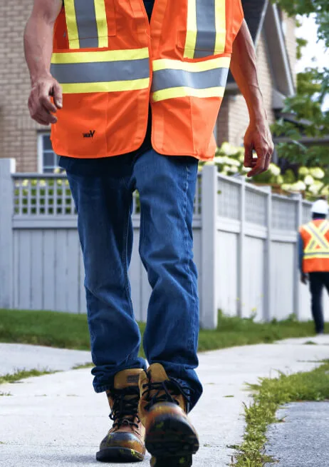 CUTI trainee in high-visibility gear walking a locate route